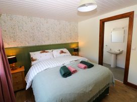 A bedroom with a bed and a sink at Dolcoed in Manordeilo near Llangadog