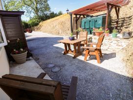An outdoor seating area with a table and chairs at Dolcoed Manordeilo near Llangadog