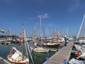 A marina with numerous sailboats docked and decorated with signal flags at Cape 14 in Yarmouth