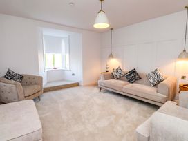A living room with sofas and an armchair at 5 Lombard Street Porthmadog