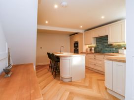 A kitchen with cabinets and countertop at 5 Lombard Street in Porthmadog