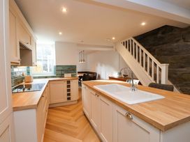 A kitchen with cabinets and a sink at 5 Lombard Street in Porthmadog