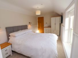 A bedroom with a bed and wardrobe at 5 Lombard Street in Porthmadog