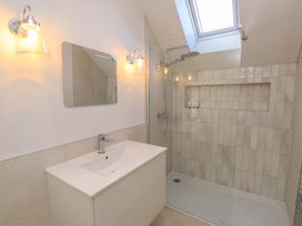 A bathroom with a shower and sink at 5 Lombard Street in Porthmadog