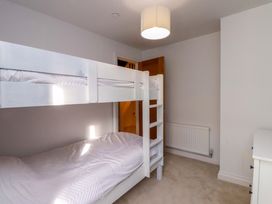 A bedroom with a bunk bed and a single bed at 5 Lombard Street Porthmadog