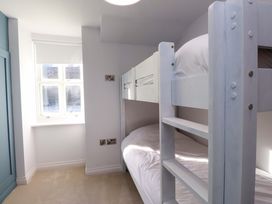 A bedroom with a bunk bed and a window at 5 Lombard Street Porthmadog