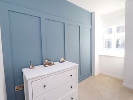 A bedroom with a dresser and decorative items at 5 Lombard Street in Porthmadog