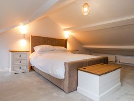 A bedroom with a bed and nightstands at 5 Lombard Street in Porthmadog