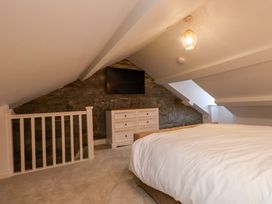 A bedroom with a bed and dresser at 5 Lombard Street in Porthmadog