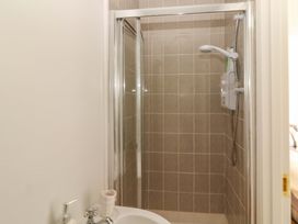A shower with tiles and faucet in the bathroom at O'Conells in Portmagee