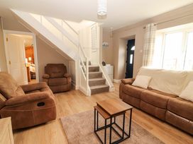 A living room with a sofa and recliner chairs at O'Connell's Lodge, Portmagee, County Kerry