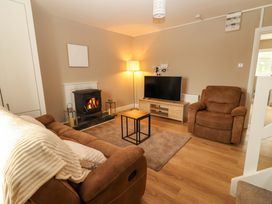 A living room with a fireplace and television at O'Connell's Lodge, Portmagee, County Kerry