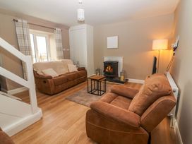 A living room with a sofa and armchair at O'Connell's Lodge, Portmagee, County Kerry
