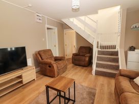A living room with a TV and seating area at O'Connell's Lodge, Portmagee, County Kerry