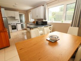 A kitchen with a dining table and chairs at O'Connell's Lodge in Portmagee, County Kerry