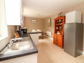 A kitchen with a sink and refrigerator at O'Connell's Lodge, Portmagee, County Kerry