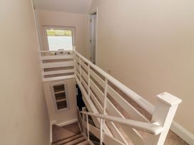 A staircase with railings and a window in a hallway at O'Connell's Lodge, Portmagee, County Kerry