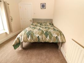 A bedroom with a bed and window at O'Connell's Lodge, Portmagee, County Kerry