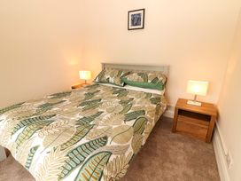 A bedroom with a bed and bedside table at O'Connell's Lodge, Portmagee, County Kerry