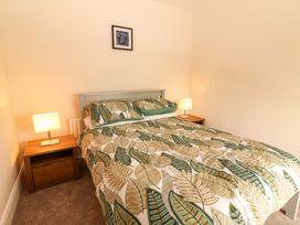 A bedroom with a bed and bedside tables at O'Connell's Lodge in Portmagee, County Kerry