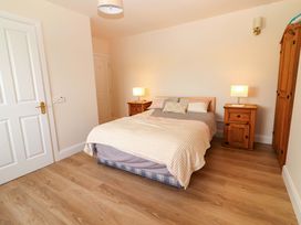 A bedroom with a bed and bedside tables at O'Connell's Lodge, Portmagee, County Kerry