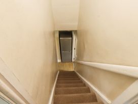 A staircase leading to a fridge at Sygun Cottage in Nant Gwynant