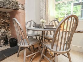 A dining room with a table and chairs at Tryfan Cottage in Nant Gwynant