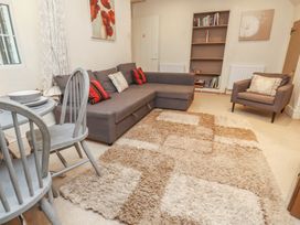 A living room with a sofa and dining table at Tryfan Cottage in Nant Gwynant