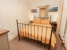 A bedroom with a bed and nightstand at Tryfan Cottage Nant Gwynant