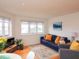 A living room with a sofa and coffee table at 61B Fore Street in Kingsbridge