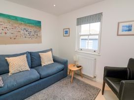 A living room with a sofa and a table at 61B Fore Street in Kingsbridge