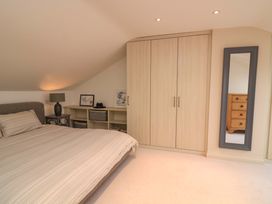 A bedroom with a bed and wardrobe at 61B Fore Street in Kingsbridge