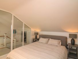 A bedroom with a bed and lamps at 61B Fore Street in Kingsbridge