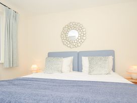 A bedroom featuring a bed with pillows and a lamp at Chimings in Rock