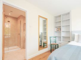 A bedroom with a shower and a mirror at Chimings in Rock