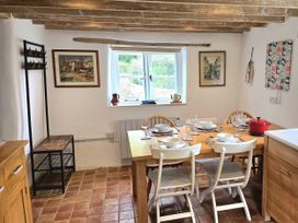 A kitchen with a dining table and chairs at Picket Mead Southleigh near Colyton