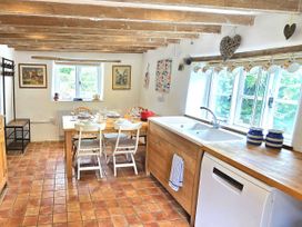 A kitchen with a table and chairs at Picket Mead Southleigh near Colyton