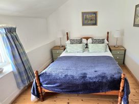 A bedroom with a bed and lamps at Picket Mead Southleigh near Colyton