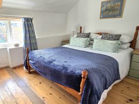 A bedroom with a bed and window at Picket Mead Southleigh near Colyton
