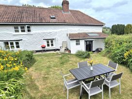 A garden with a table and chairs at Picket Mead Southleigh near Colyton