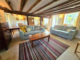 A living room with sofas and a wooden table at Picket Mead Southleigh near Colyton