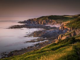 A coastline with cliffs and ocean at 16 Manleigh Park in Combe Martin