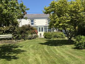 A house with a garden and bench in front at Nanvivian Feock near Truro