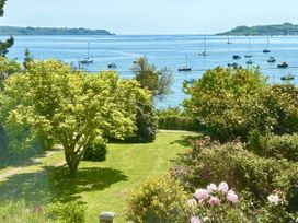 A garden with a view of water and boats at Nanvivian Feock near Truro