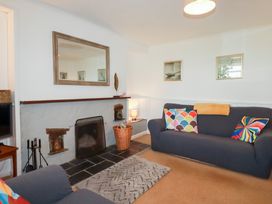 A living room with a fireplace and a sofa at Nanvivian Feock near Truro