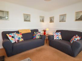 A living room with sofas and a lamp at Nanvivian in Feock near Truro