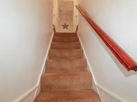 A staircase with carpet and a handrail at Nanvivian in Feock near Truro