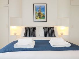 A bedroom with a bed, pillows, and a picture at Nanvivian in Feock near Truro