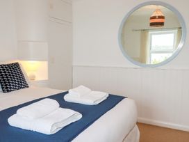 A bedroom with towels on the bed at Nanvivian in Feock near Truro