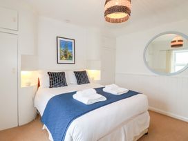 A bedroom with a bed and artwork at Nanvivian in Feock near Truro